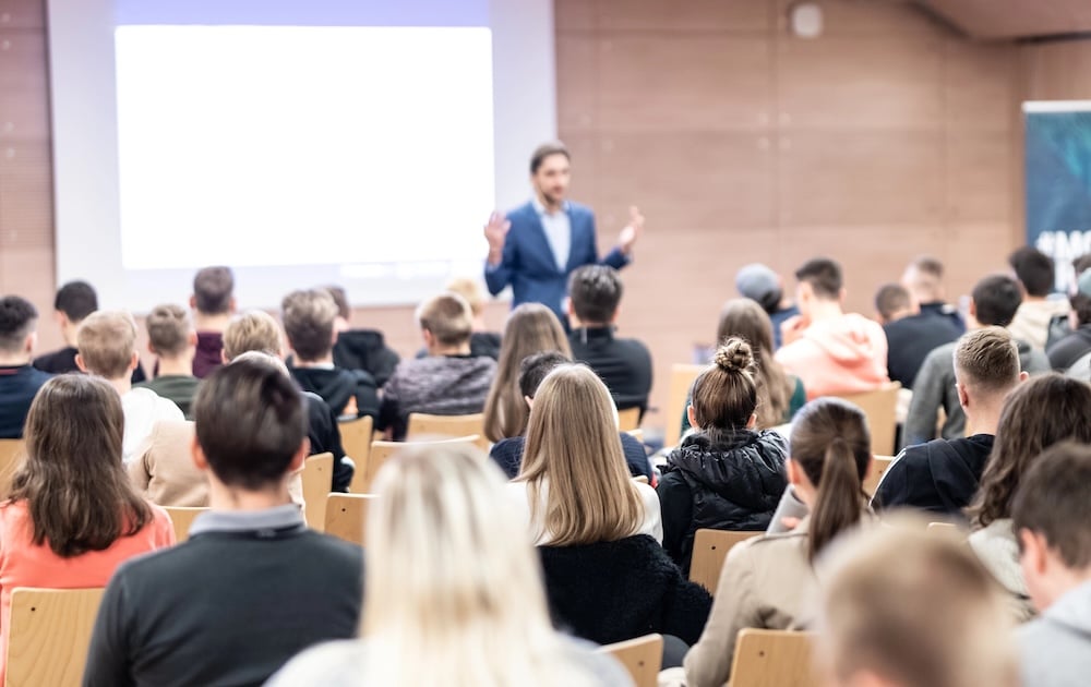 Business speaker giving a talk at business conference event.